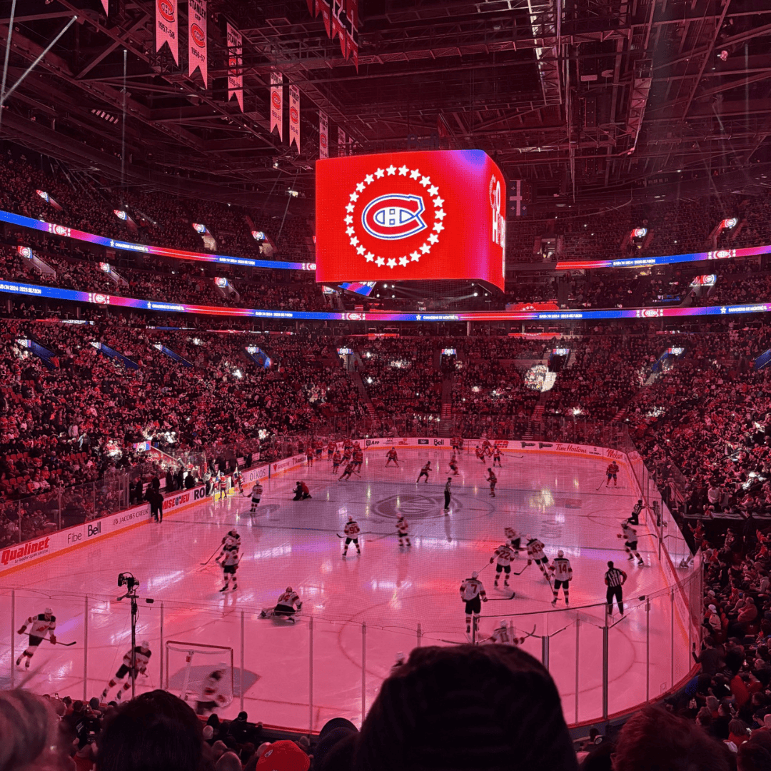Montreal Canadiens arena during a game with fans and players on ice.